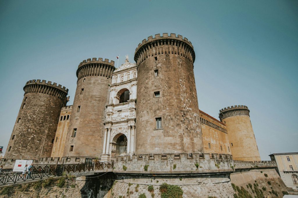 34 Incredible Weekend Trips From Barcelona 42 Castel Nuovo, a medieval fortress with its iconic trapezoid layout and round towers, stands as a historic landmark under the clear skies of Naples, Italy.