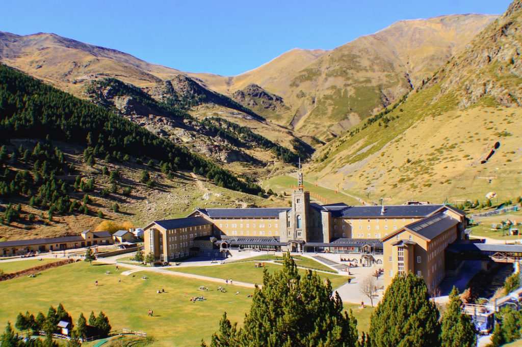 34 Incredible Weekend Trips From Barcelona 28 The Vall de Núria mountain resort and sanctuary in the Catalan Pyrenees, with a grand hotel and central basilica nestled in a valley surrounded by green slopes and rugged mountain peaks.