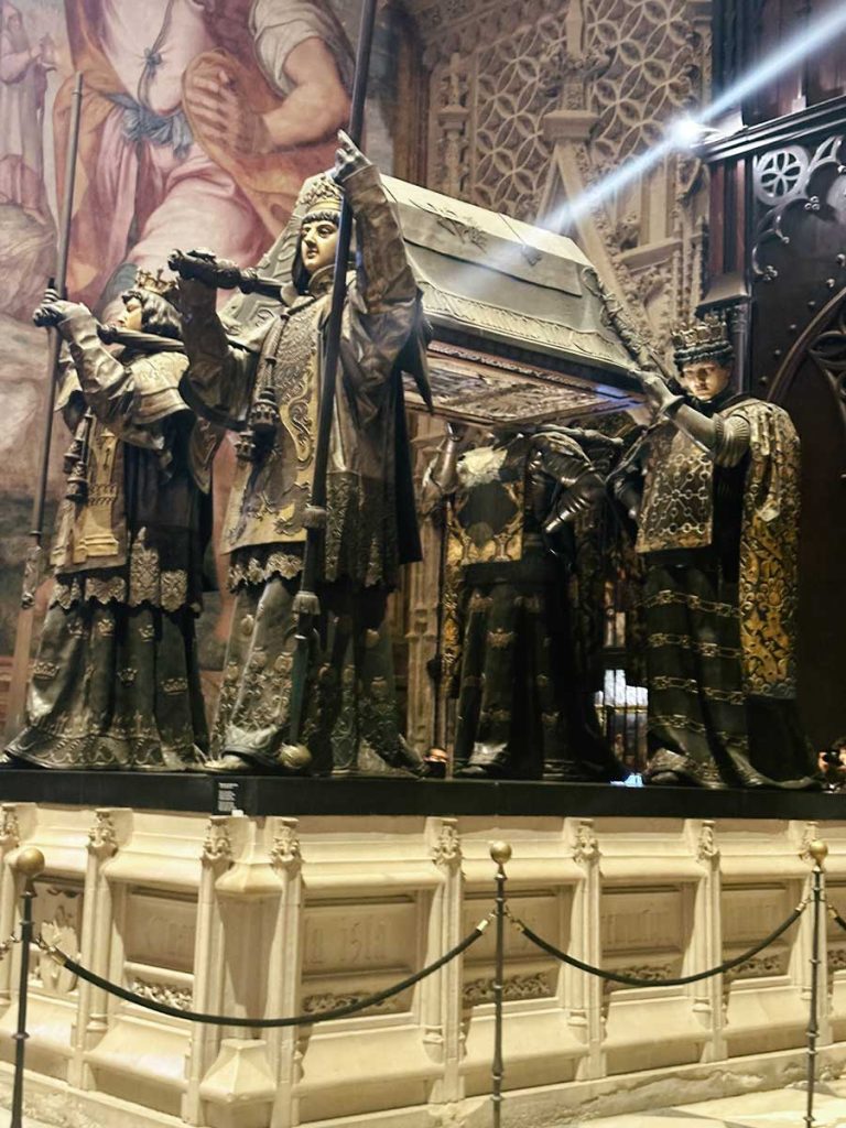 3 Most Amazing Days In Seville, Spain 23 Monumental tomb of Christopher Columbus carried by four statues representing kingdoms, set in the ornate interior of Seville Cathedral.